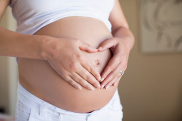 Pregnant woman making heart shape